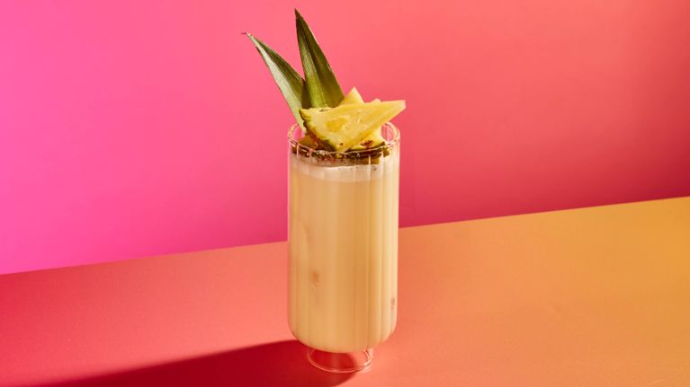 A glass of coconut-pineapple agua fresca.