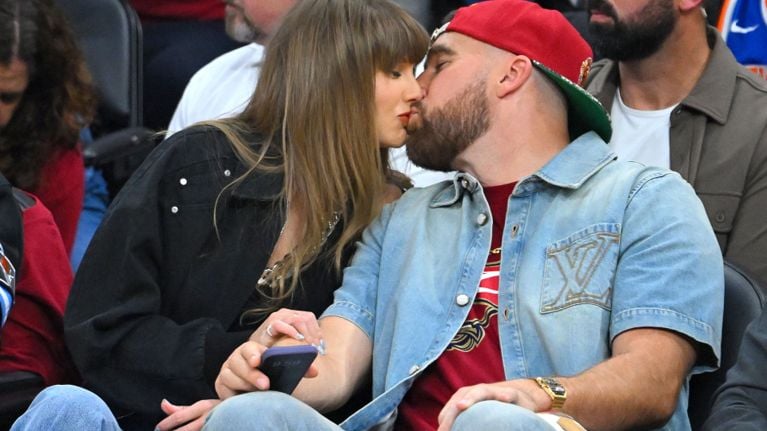 CLEVELAND, OHIO - MAY 23: (L-R) Singer Taylor Swift and Travis Kelce of the Kansas City Chiefs kiss during Game Three between the New York Knicks and the Cleveland Cavaliers in the NBA Eastern Conference Finals at Rocket Arena on May 23, 2026 in Cleveland, Ohio. NOTE TO USER: User expressly acknowledges and agrees that, by downloading and or using this photograph,