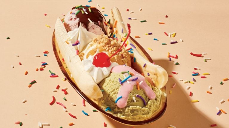 A bowl of ice cream drizzled in peanut brittle sauce.