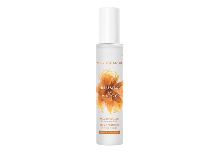 A bottle of Moroccanoil Brumes du Maroc Ambiance de Plage Hair & Body Fragrance Mist for an article about the best new perfumes for summer 2026.