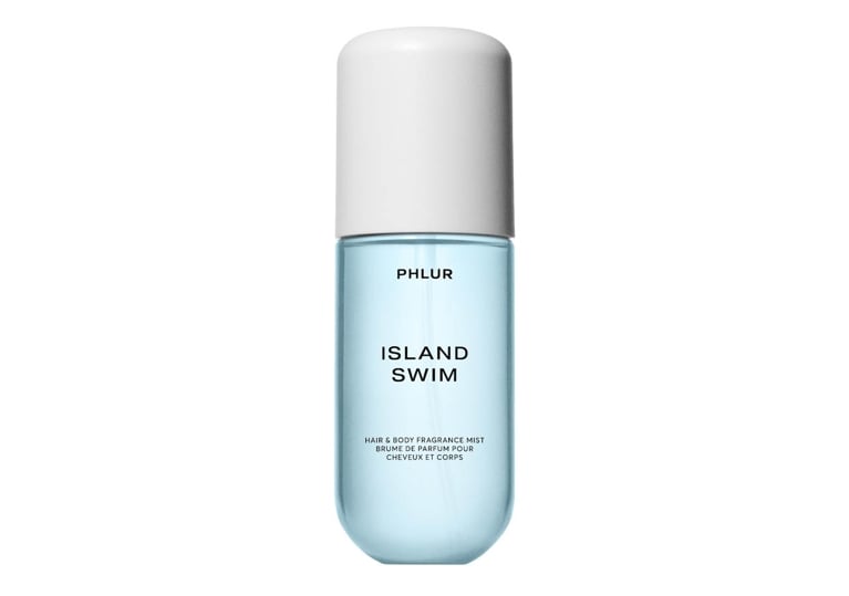 A bottle of Phlur Island Swim Hair & Body Fragrance Mist for an article about the best new perfumes for summer 2026.