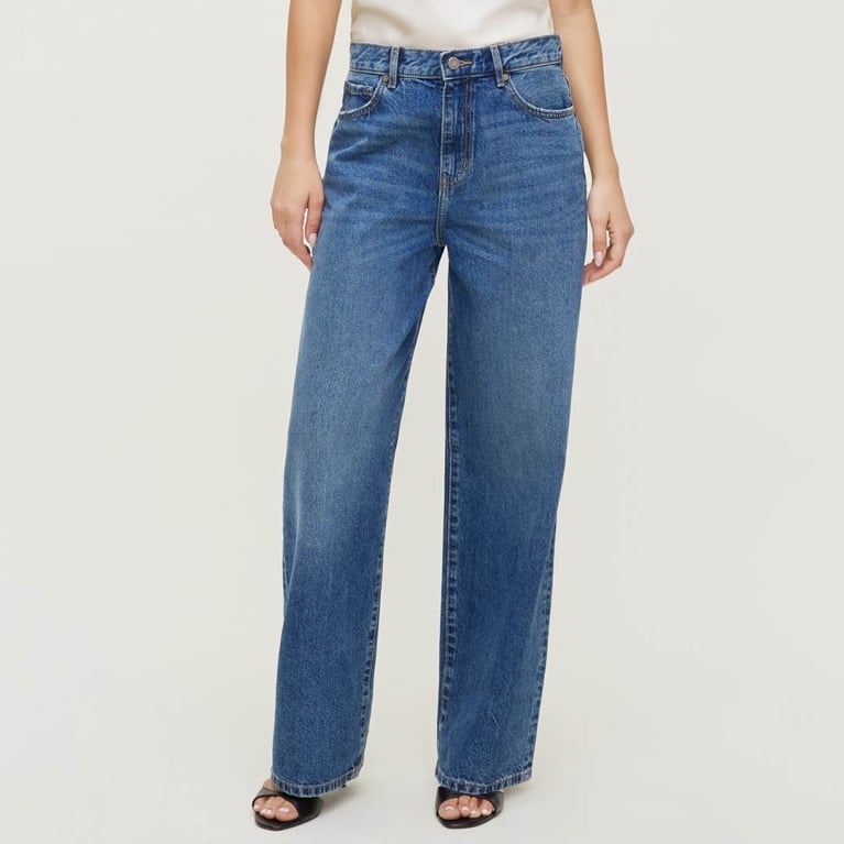 A model wearing a pair of jeans from Dynamite for an article about the best purchases our editors made in June 2026.