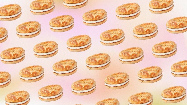 A repeating pattern of tim hortons protein bagels on a pink background.